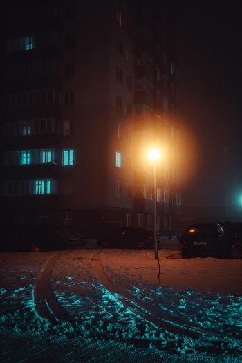 Black Vehicle Parks Beside Gray Concrete Building