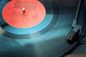 Black Vinyl Record Playing on Turntable