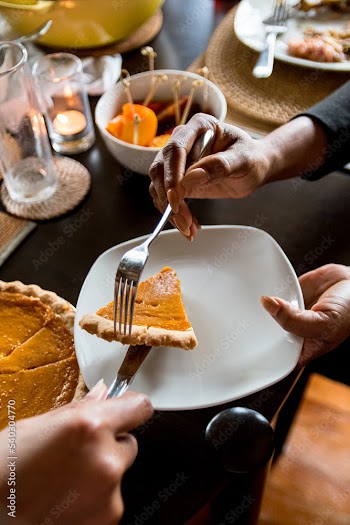 Black woman hands serving a slice of sweet potato pie after Sunday dinner, soul food