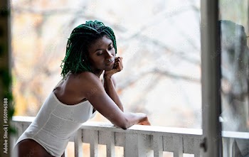 Black woman in deep thought on patio