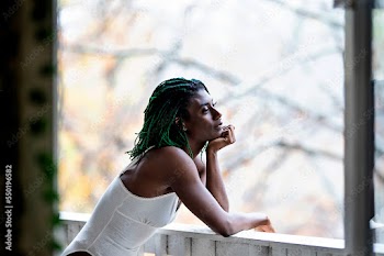 Black woman on patio smiling about the day