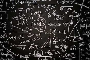 Blackboard inscribed with scientific formulas and calculations Free Photo