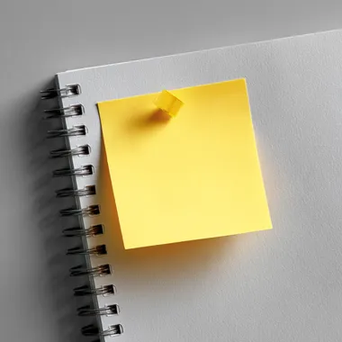 Blank Sticky Note on Paper Surface Blank Sticky Note on Paper Surface