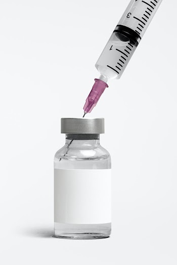 Blank white label on injection bottle glass vial with syringe