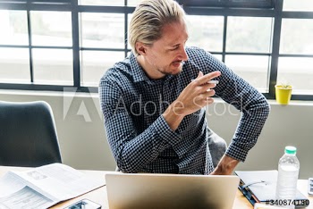 Blond man busy at work