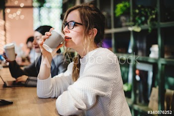 Blond woman having a cup of coffee