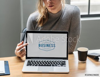 Blond woman pointing at a laptop screen