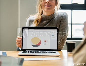 Blond woman pointing at a laptop screen