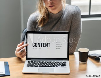 Blond woman pointing at a laptop screen
