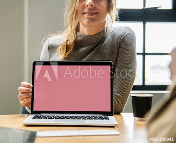 Blond woman pointing at a laptop screen
