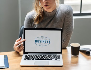 Blond woman pointing at a laptop screen | Free stock psd mockup - 414308