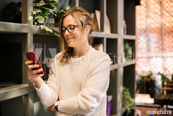 Blond woman texting on her phone