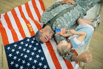 Blonde cute girl meeting her American hero at home