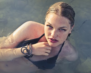 Blonde Haired Woman Wearing Black Bikini in Body of Water