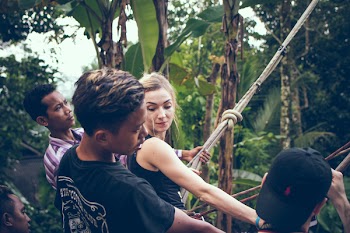 Blonde Haired Woman Wearing Black Tank Top Holding Rope
