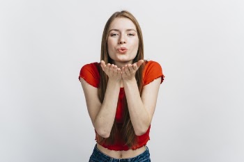 Blonde woman blowing kisses Free Photo