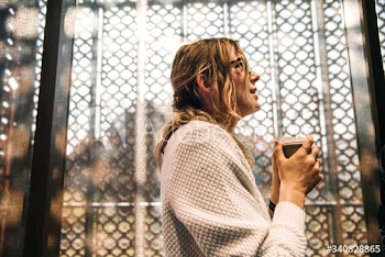 Blonde woman drinking hot coffee
