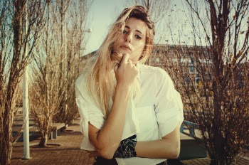 Blonde Woman in White Dress Shirt Beside Brown Plants