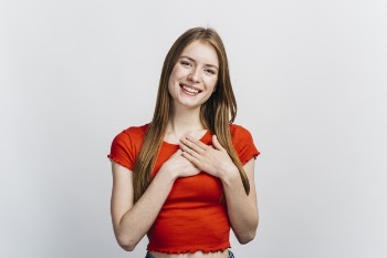 Blonde woman looking flattered Free Photo