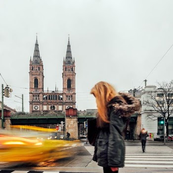 blonde woman wearing winter coat standing on roadside timelapse photography