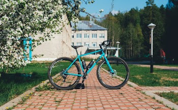 Blue and Black Bicycle Parked on the pavement