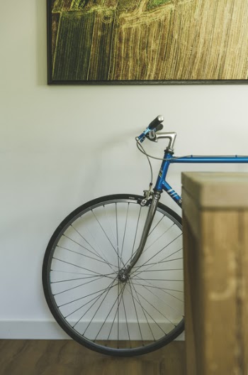 Blue and Black Bike Near Wall