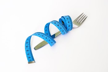 Blue and Black Measuring Tape Wrapped Around a Silver Metal Fork