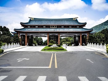 Blue and Brown Temple Near Gray Pavement Road