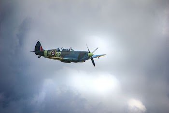 blue and green aircraft flyin in the sky