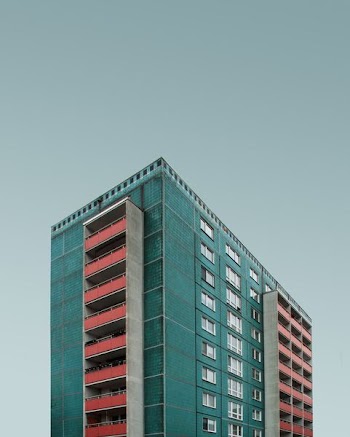 blue and white building under dark clouds