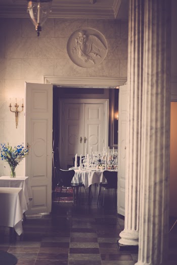 Blue and White Flowers in Vase on Table Near Door
