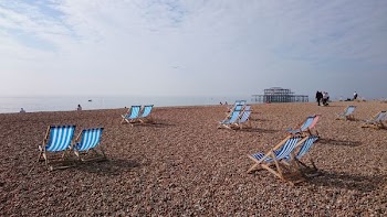 blue and white wooden chairs near seaside
