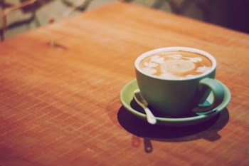 Blue Ceramic Cup With Saucer on Brown Surface
