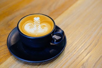 blue ceramic mug filled with cappuccino