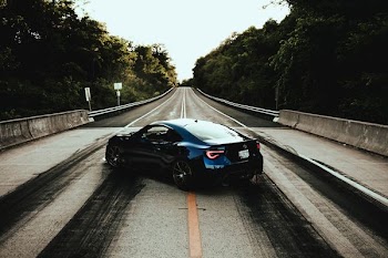 blue coupe of road