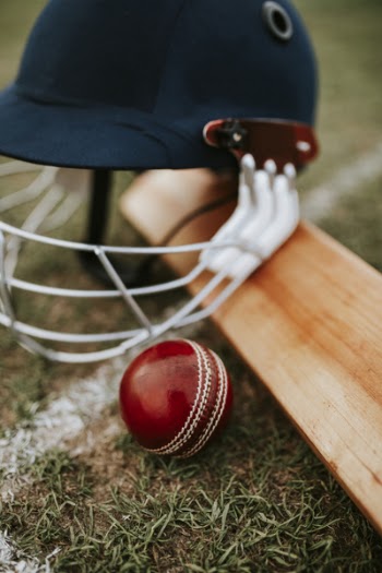 Blue Cricket Helmet and Red Ball
