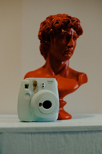 Blue Fujifilm Instax Mini Camera Near Man Head Bust