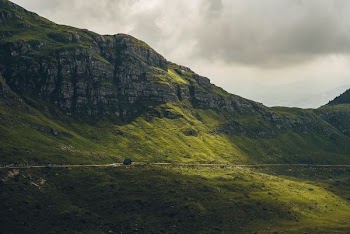 blue house near cliff during daytime
