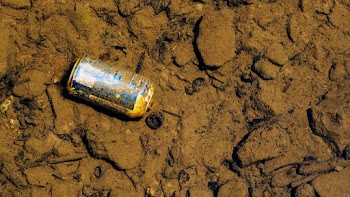 Blue Labeled Can on Sand