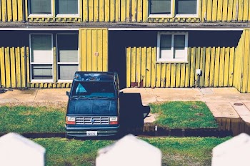 blue pickup truck packed on green grass