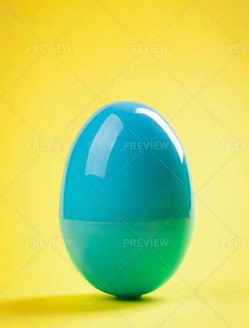 Blue Plastic Egg On A Yellow Background