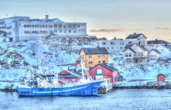Blue Ship Park Beside Red Houses