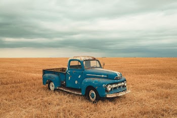 Blue Single Cab Farm Truck on Brown Grassland