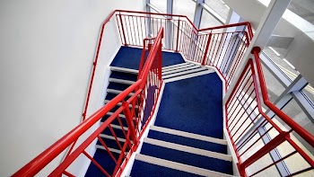 Blue Stairs and Red Handled on White Paint Wall