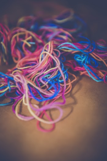 Blue Teal Pink Orange and Yellow Yarn Tangled With Each Other