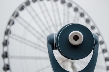 Blue Tower Viewer in Front of Ferris Wheel