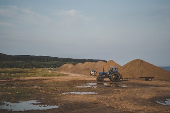 Blue Tractor on Brown Field