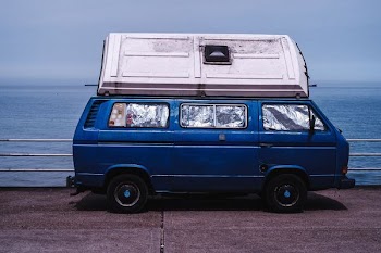 blue van with container on roof