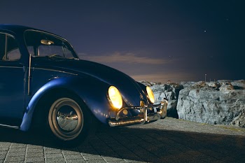 Blue Volkswagen Beetle Car Near Cliff during Night Time