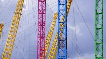 Blue Yellow Red and Green Metal Bar With Metal Sprint in Low Angle Photography